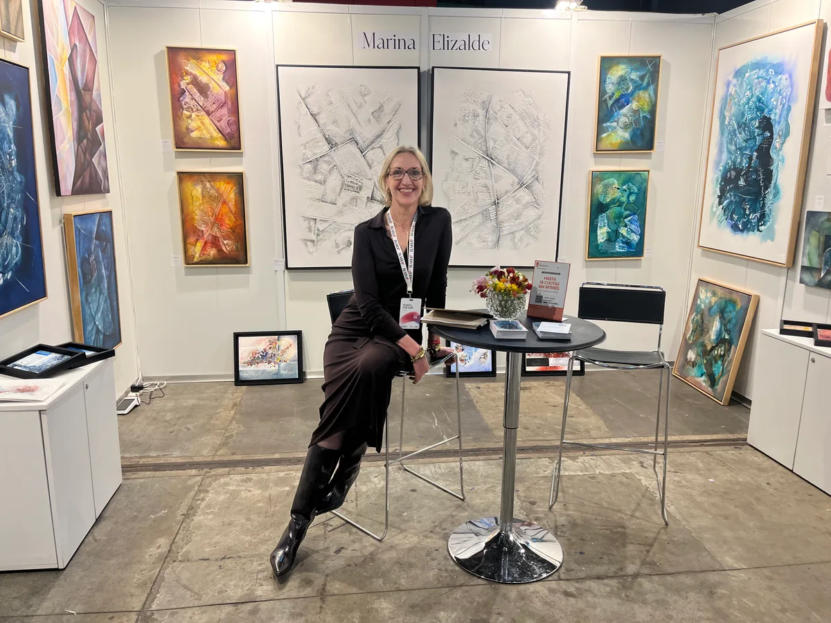 Marina Elizalde sitting at her booth at BADA 2025