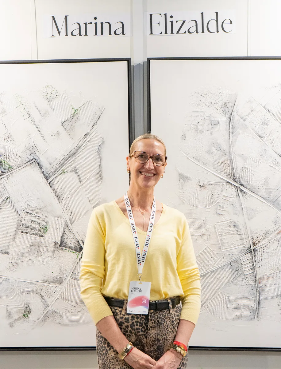Marina Elizalde in front of her white and grey works from the Mapas series