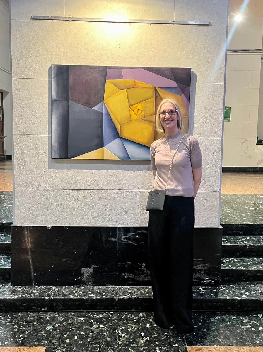 Marina Elizalde next to one of her paintings