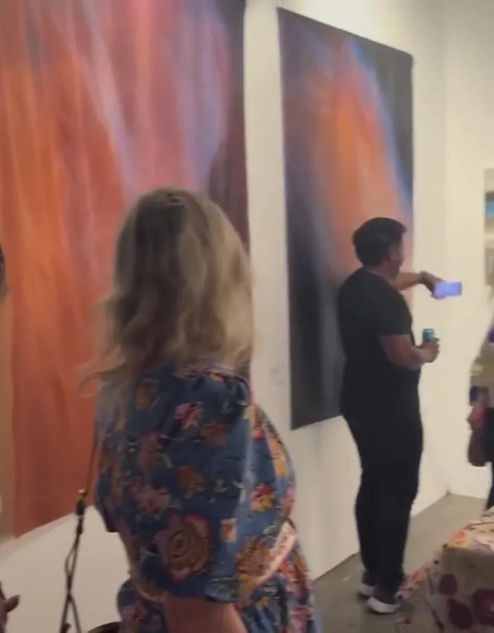 Visitors walking through the booth at the Seattle Art Fair